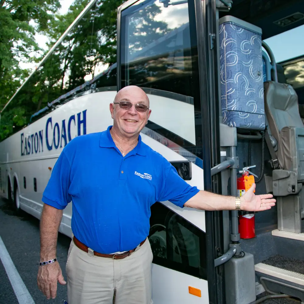 a man standing next to a bus