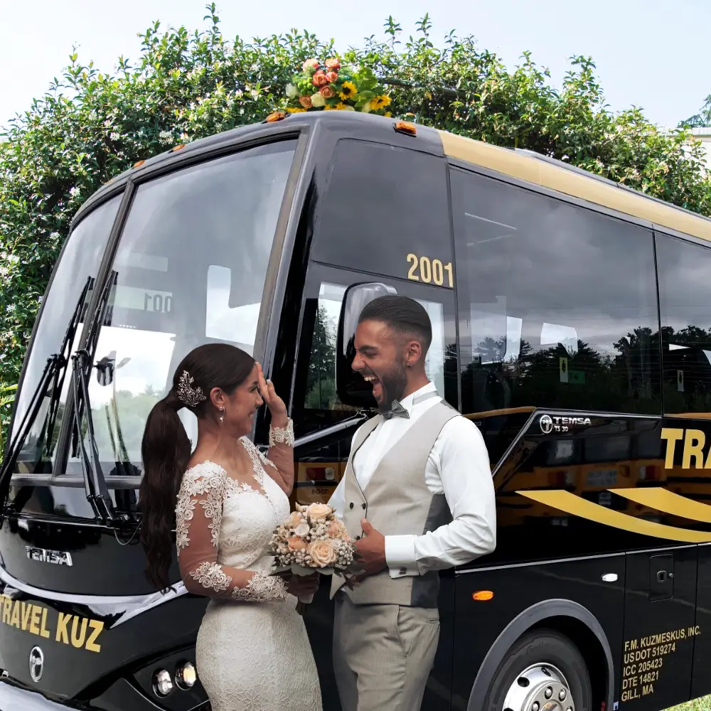a man and woman standing next to a bus
